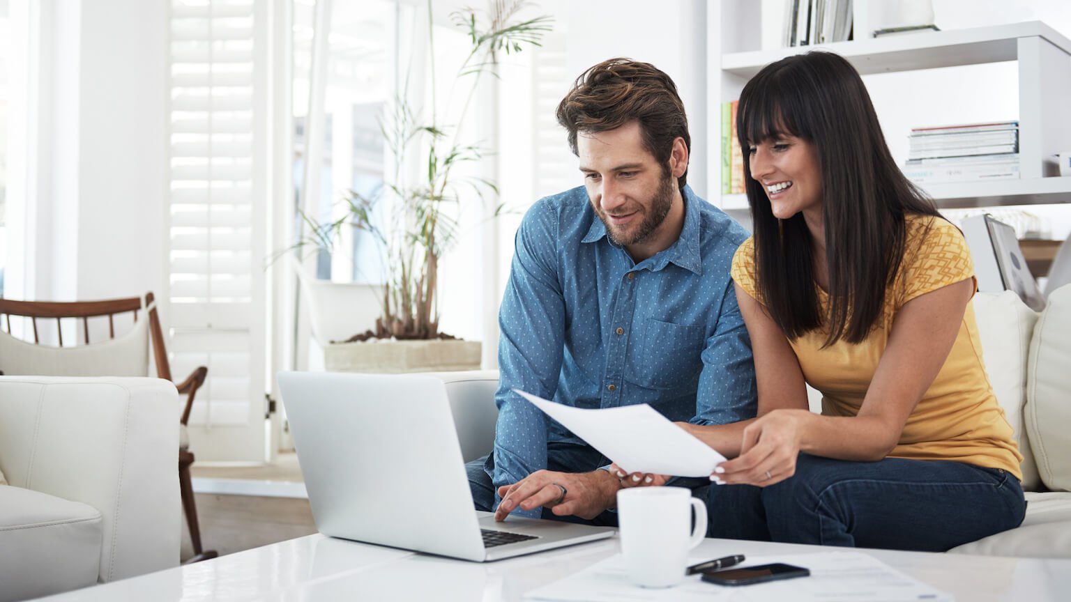 HappyCoupleLookingAtBills_GettyImages_1536x864