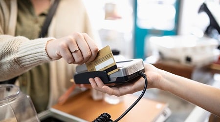 Debit card being swiped in a POS station