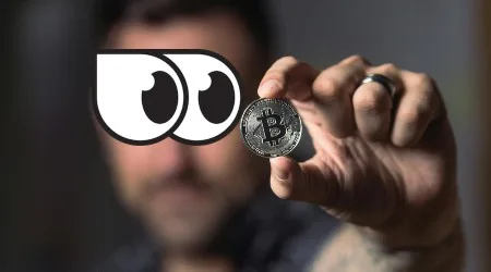 Man holding up a Bitcoin