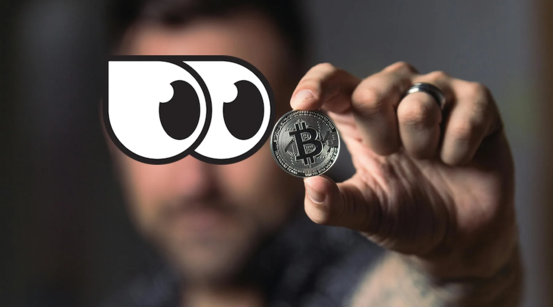 Man holding up a Bitcoin