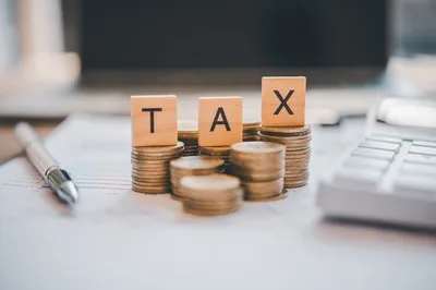 Scrabble tile that spells TAX