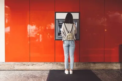 Woman facing an ATM