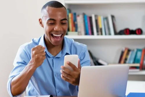 Man excited seeing something on his cellphone