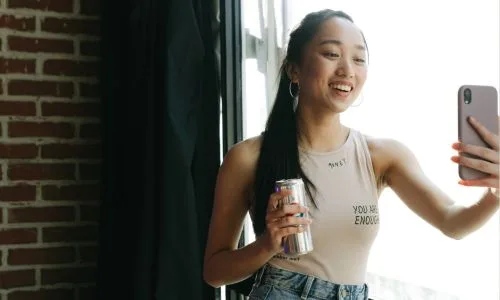 Woman taking a picture with a drink