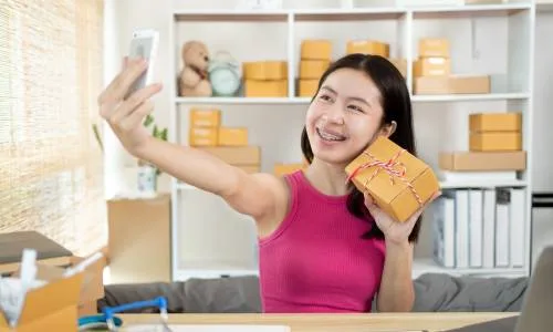 Woman taking a selfie with a package