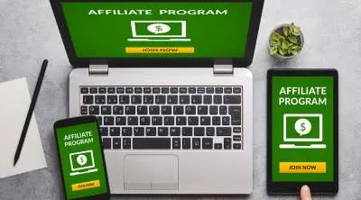 A laptop, cellphone and table showing an Affiliate program on the screen