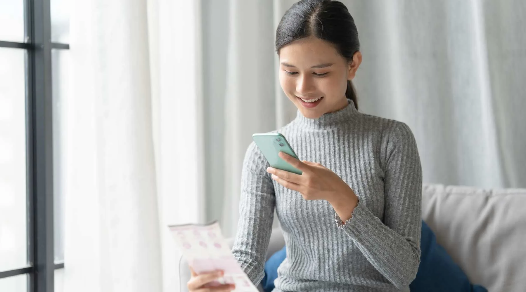 Woman Scanning Receipt with her cellphone 